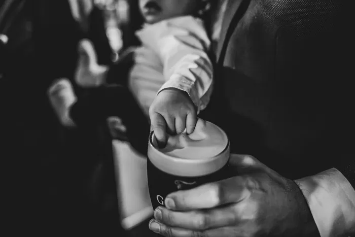 Hands reaching in to lift a pint from the table