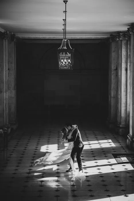 A child dancing alone down a long sunlit hallway